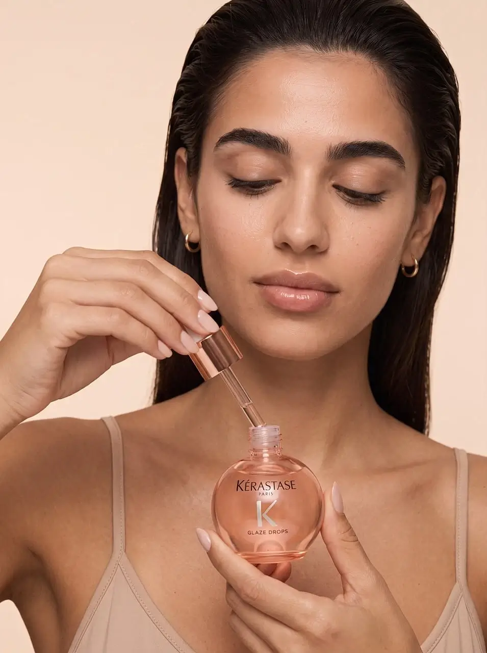 A girl closes a bottle of aromatic oil