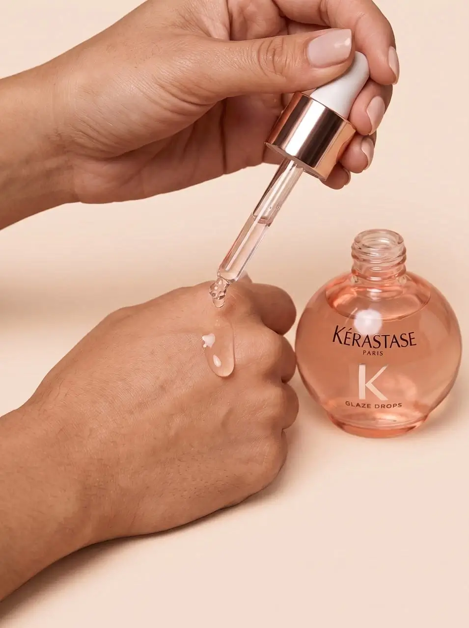 A girl drips aromatic oil onto her hand