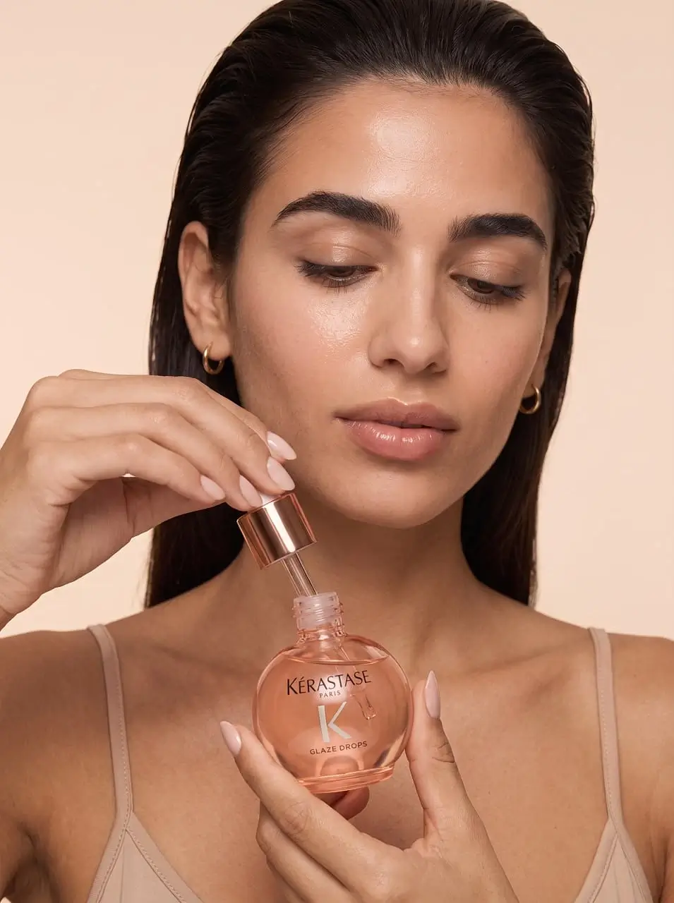 A girl opens a bottle of aromatic oil