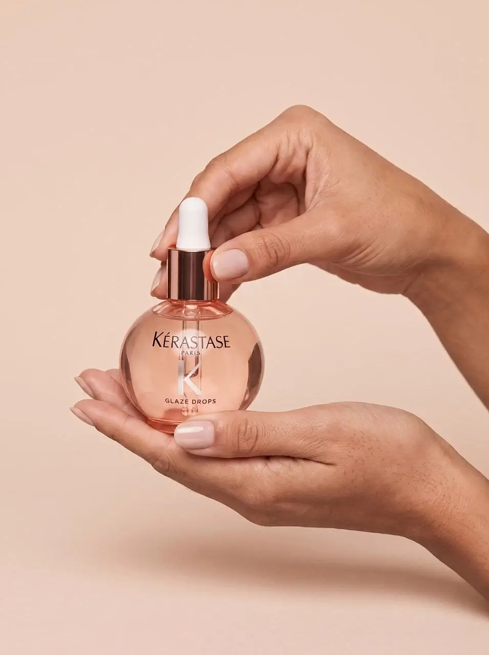 a girl holds aromatic oil in her hands